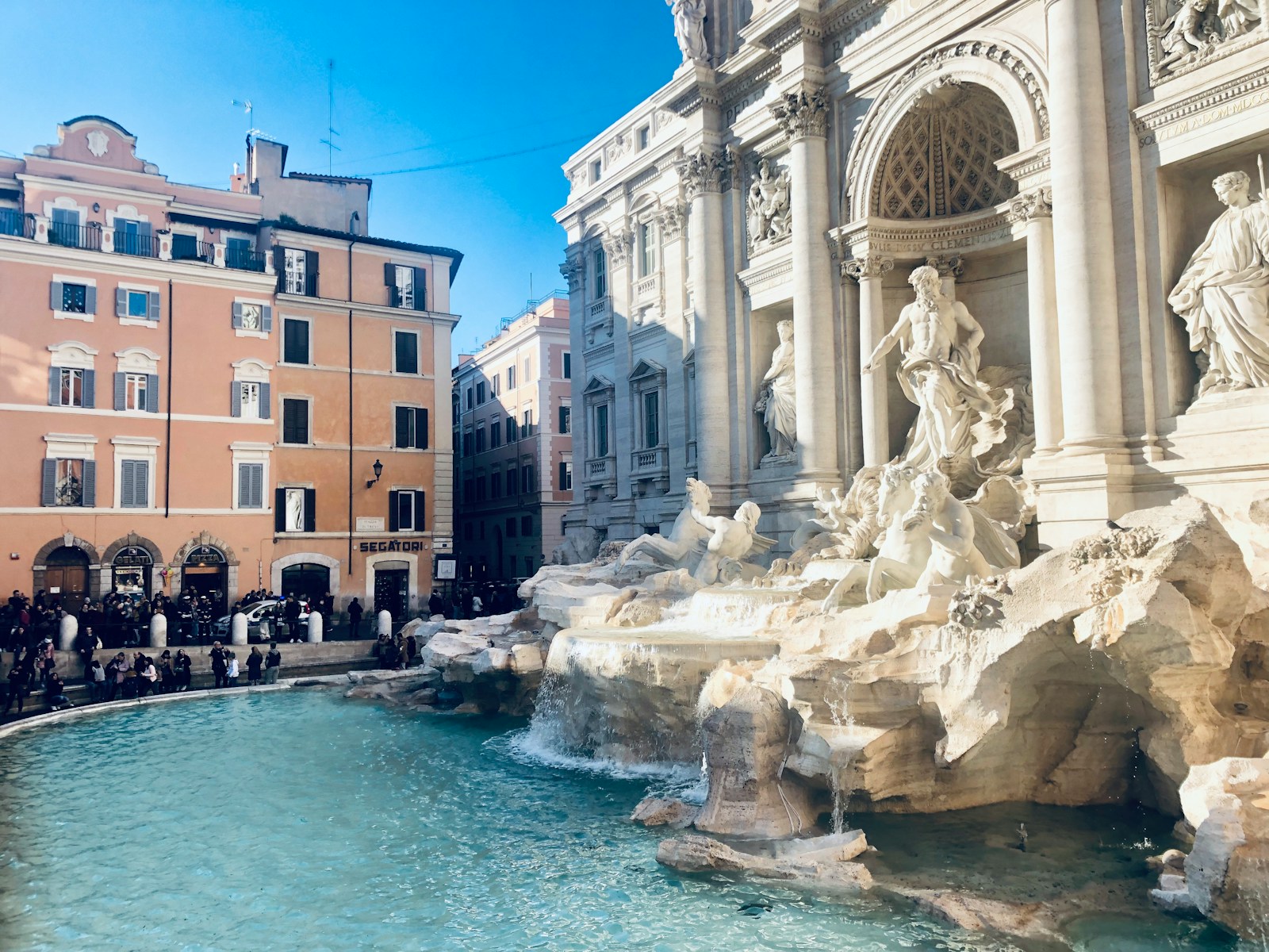 a group of people standing around a fountain